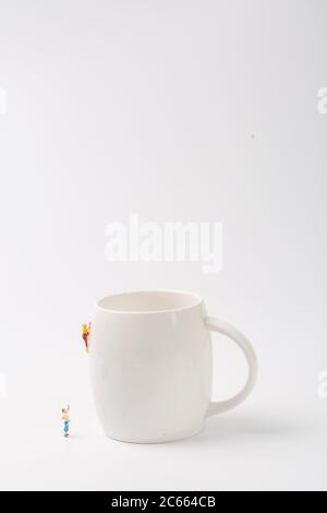 Man climbing cup on white background Stock Photo