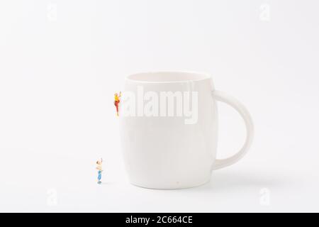 Man climbing cup on white background Stock Photo