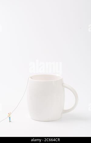 Man climbing cup on white background Stock Photo