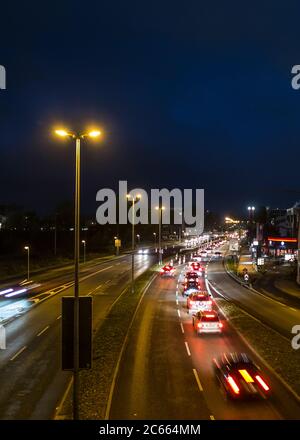 Traffic at night on an illuminated city street Stock Photo