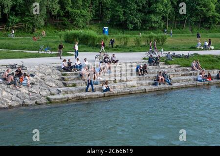 People on the banks of the Isar with stairs to the river, Munich, Bavaria, Germany Stock Photo