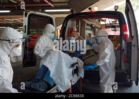 Paramedics of MDA Magen David Adom emergency medical service wearing protective clothing, as a preventive measure against the coronavirus, evacuate an elderly patient suspected to have COVID-19 at a hospital in Jerusalem. Israel Stock Photo