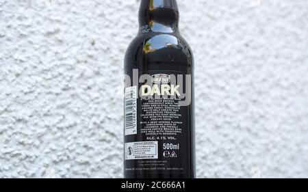 Dark beer bottle from Brains brewery on light textured background. Stock Photo