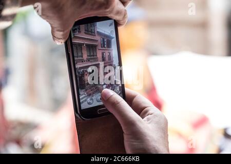 Tourist photographs with her mobile phone the temple complex of Swayambhunath near Kathmandu in Nepal Stock Photo