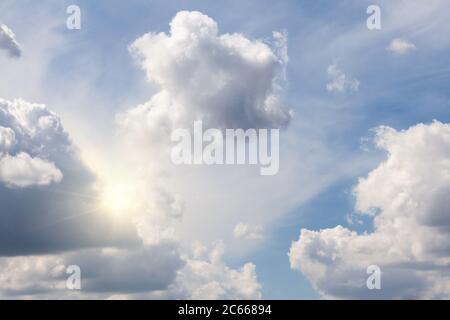 Morning sun light peeking out from a beautiful cloudscape sky. Dramatic nature background with natural lighting in the sky Stock Photo
