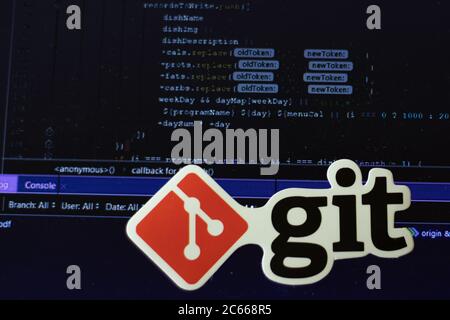 Moscow, Russia - 1 June 2020: Git logo sign with program code on background Illustrative Editorial Stock Photo