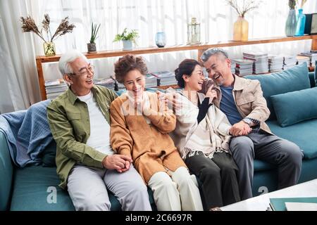 The two chat happy old couple sitting on the sofa Stock Photo