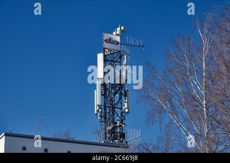 Joensuu, Finland - March 20, 2020: Cellular phone network telecommunication tower Elisa with 5G equipment on the building roof. Stock Photo