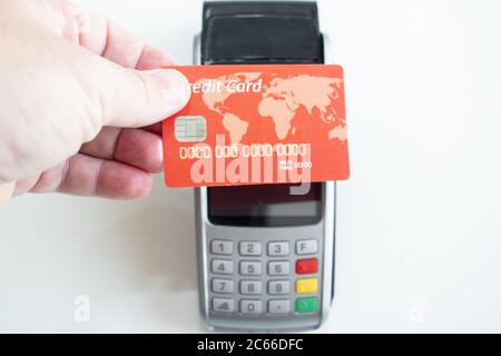 red Credit Card And Pos Terminal On White Stock Photo