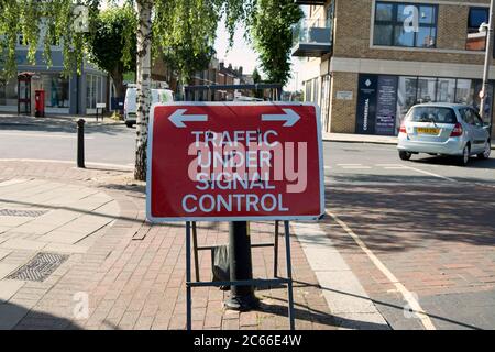 british road sign indicating traffic on the road ahead being under signal control, in twickenham, middlesex, england Stock Photo