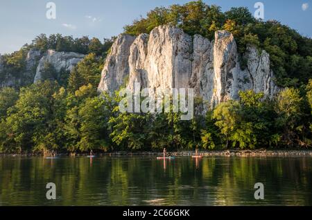 Water sports enthusiasts on stand-up paddleboards in the Weltenburg Narrows near Weltenburg Abbey Stock Photo