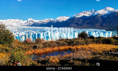 View of Perito Moreno Glacier, autumnal landscape in the foreground, El Calafate, Argentina Stock Photo