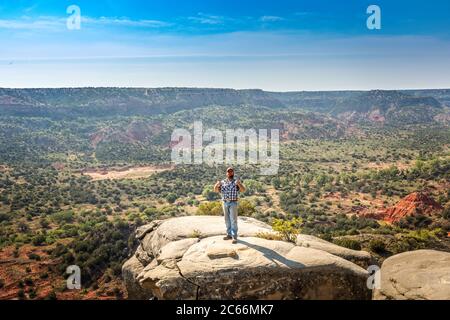 Man standing on the edge of a cliff, Palo Duro Canyin State Park, Texas Stock Photo