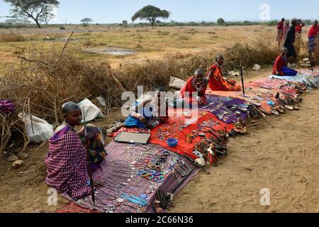 MASAI MARA, KENYA - AUG 23: Local sellers from Masai tribe offer goods in the market, on Aug 23, 2010 in Masai Mara. Traditional handmade accessories Stock Photo
