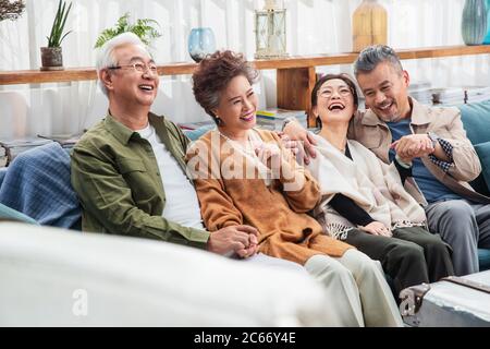 The two chat happy old couple sitting on the sofa Stock Photo