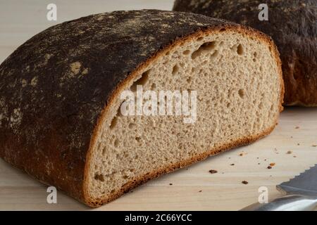 Half fresh loaf of healthy German Sourdough bread close up Stock Photo