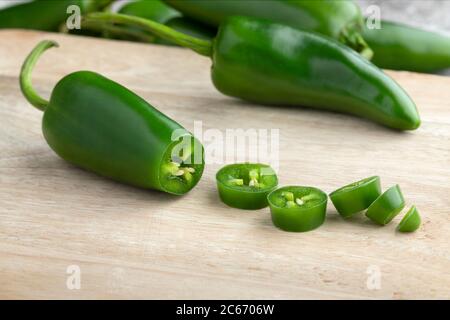 Fresh green jalapeno peppers and slices close up Stock Photo