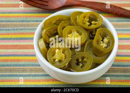 Bowl with sliced pickled jalapeno peppers Stock Photo