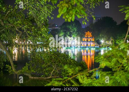 The iconic turtle tower at night in Hoan Kiem Lake in Hanoi