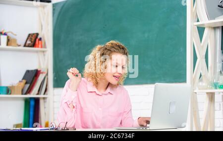 observe the computer. teacher woman. teachers day. online education. freelancer work. modern technology. girl Study Online in Classroom. IT Lesson with Computer. e-learning. student with laptop. Stock Photo