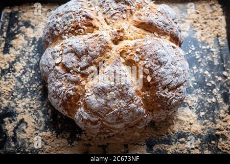 Close up photograph of a home baked simple soda bread just brought out from the oven. Stock Photo