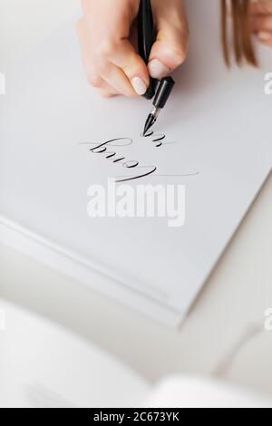 Close up photo of woman hands holding pen and writing beautiful postcard isolated Stock Photo