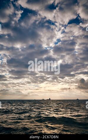 Sunset over the rough ocean. Stock Photo