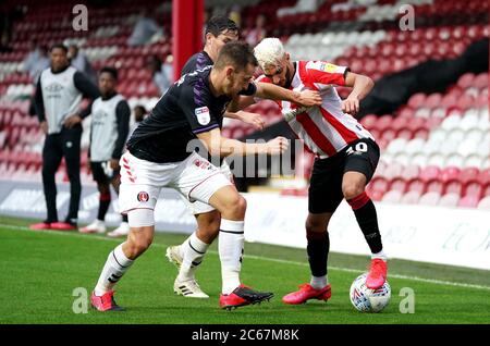 Charlton Athletic's Tom Lockyer (left) and Brentford's Said Benrahama (right) battle for the ball during the Sky Bet Championship match at Griffin Park, London. Stock Photo