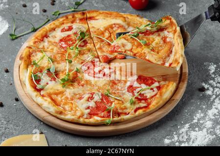 Pizza Margherita on black stone background, top view. Pizza Margarita with Tomatoes, Basil and Mozzarella Cheese close up Stock Photo