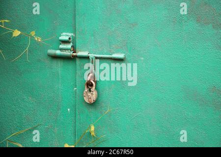 Hanging padlock locked hanging on garage door. Concept of secret information Stock Photo