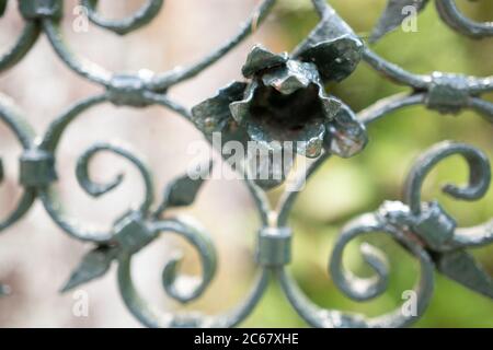 welded iron metallic design flower detail closeup garden fence Stock Photo