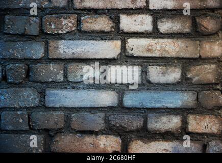 Old weathered grey brick wall closeup background Stock Photo
