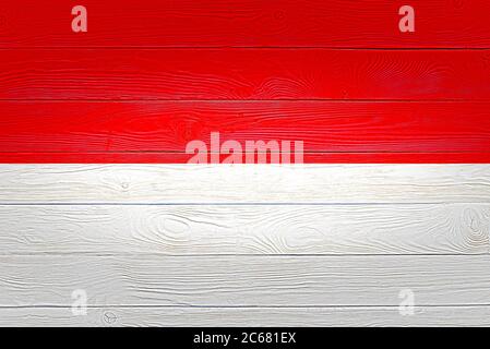 Indonesia flag painted on old wood plank background. Brushed wooden board texture. Wooden texture background flag of Indonesia. Stock Photo