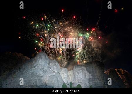 Fireworks explode over the colossal sculpture faces at Mount Rushmore National Memorial during the Salute to America Independence Day celebration July 3, 2020 in Keystone, South Dakota. Stock Photo