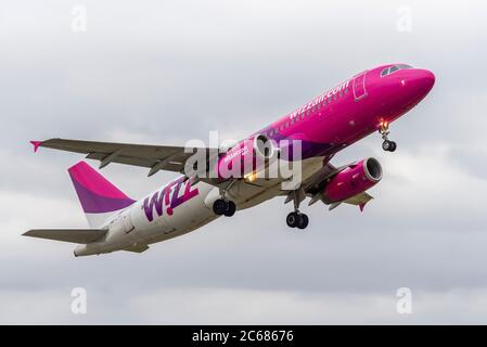 First Wizz Air airline service from London Southend Airport, Essex, UK since the COVID-19 Coronavirus lockdown, heading to Bucharest, in cloudy sky Stock Photo