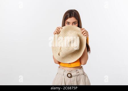 Hiding face behind the hat. Stylish beautiful young girl in bikini stands  and posing in the studio Stock Photo - Alamy
