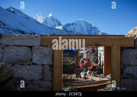 workers build a guest house in Nepal's Khumbu Valley near Ama Dablam. Stock Photo