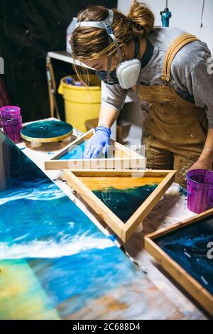 Female resin working in homemade studio Stock Photo