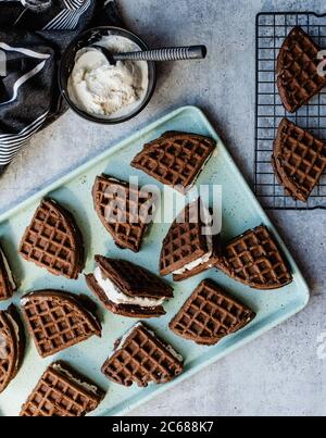 Homemade ice cream sandwiches and ingredients on green sheet pan. Stock Photo