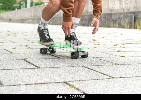 Close-up of Skateboarder doing a trick at the park. Concept of leisure activity, sport, extreme, hobby and motion. Stock Photo