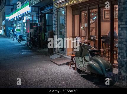 Old vespa motorcycle in the street sidewalk of Kamimeguro, Tokyo, Japan. Stock Photo