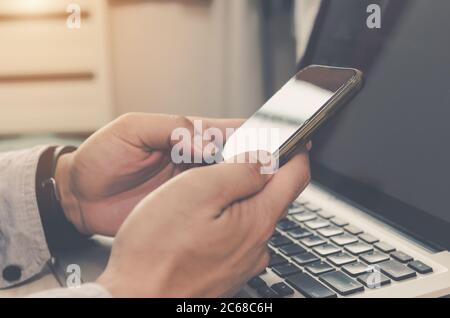 Man with a hand holding a smartphone on social media.Digital network  concept. Stock Photo
