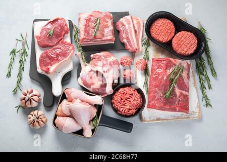 Assortment of raw meats on grey background. Top view, flat lay Stock Photo