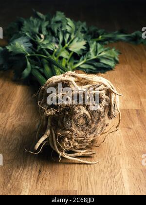 A sandy celeriac on a rustic oak kitchen table, concept for natural healthy eating Stock Photo