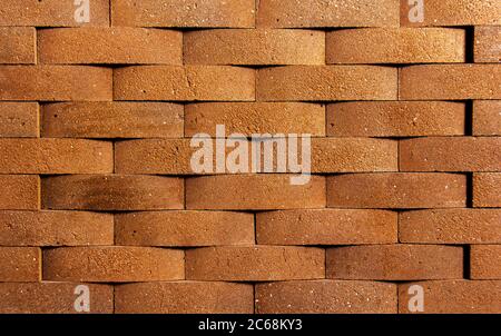 Irregular orange brick arrangement. brickwall. Stock Photo
