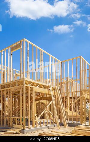 New residential construction home framing. Blue sky and white clouds background. Stock Photo