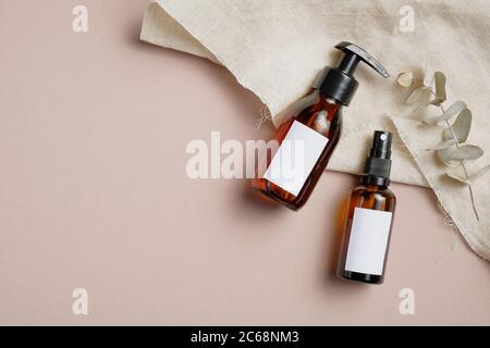 Download Amber Glass Cosmetic Bottles Set With Towel And Eucalyptus Leaves On Beige Background Beauty Products Packaging Mockups With Blank White Labels Skin Stock Photo Alamy