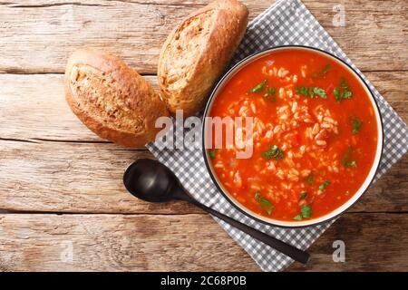 Thick vegetarian tomato soup with rice close-up in a bowl on the table. horizontal top view from above Stock Photo