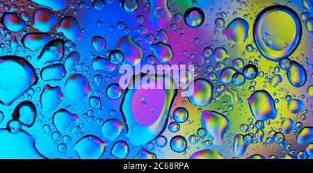 Oil bubbles in water. blue, yellow and purple colors.