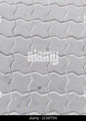 Gray urban pavement floor tiles with chewing gum, top view. Grey geometric background. Stock Photo